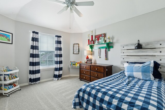 carpeted bedroom with baseboards and a ceiling fan