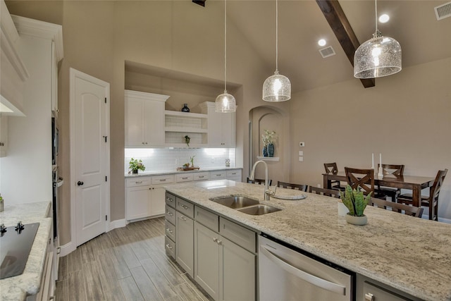 kitchen featuring visible vents, a sink, backsplash, and dishwasher
