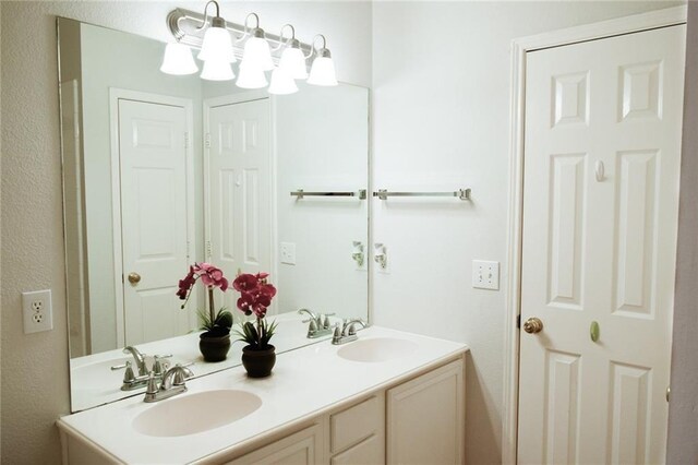 10408 Ambergate Ln, Frisco, TX 75035 - full bathroom featuring double vanity, a sink, and a textured wall