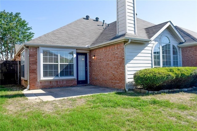 10408 Ambergate Ln, Frisco, TX 75035 - rear view of house with a chimney, a lawn, a patio area, brick siding, and fence
