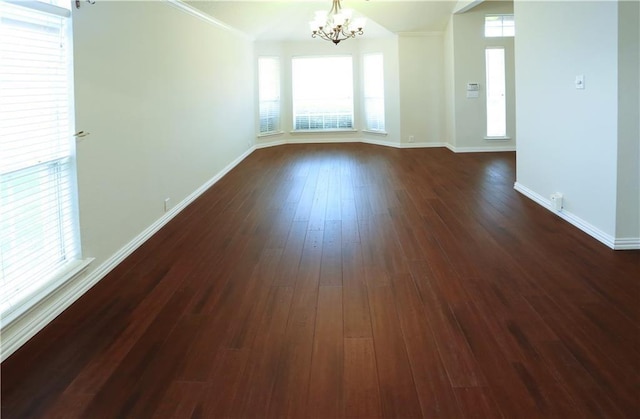 10408 Ambergate Ln, Frisco, TX 75035 - empty room featuring a notable chandelier, a wealth of natural light, and dark wood finished floors