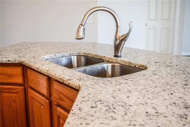 10408 Ambergate Ln, Frisco, TX 75035 - interior details with a sink, light stone countertops, and brown cabinets