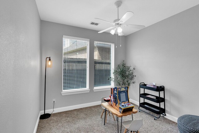 sitting room featuring visible vents, a ceiling fan, carpet, and baseboards
