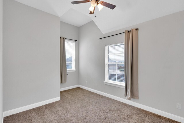 empty room featuring baseboards, a ceiling fan, carpet, and vaulted ceiling