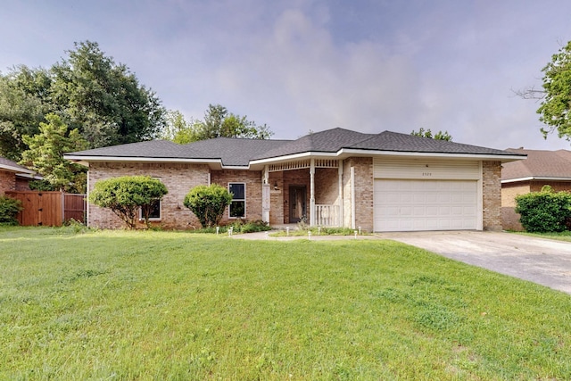 ranch-style house featuring an attached garage, brick siding, driveway, and a front yard