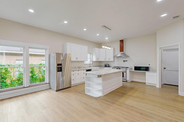 kitchen with visible vents, open shelves, light wood finished floors, stainless steel appliances, and wall chimney exhaust hood