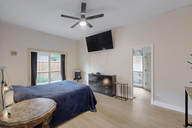 bedroom with a ceiling fan, baseboards, and light wood-style floors