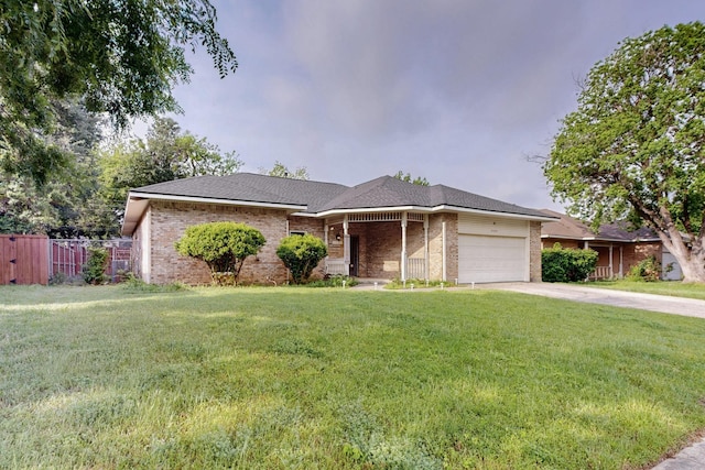 ranch-style home with brick siding, a front lawn, an attached garage, and fence
