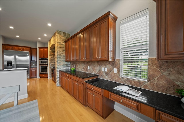 kitchen with light wood-style floors, decorative backsplash, stainless steel appliances, and recessed lighting