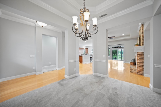 interior space with visible vents, ornamental molding, a raised ceiling, and light colored carpet