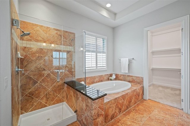 full bathroom featuring a stall shower and a bath