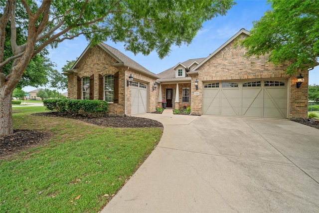 view of front of house featuring brick siding, driveway, a front lawn, and a garage