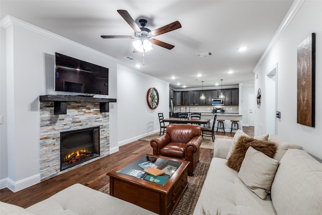 living room featuring ornamental molding, wood finished floors, and visible vents