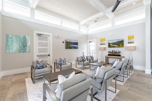 living room with baseboards and beam ceiling