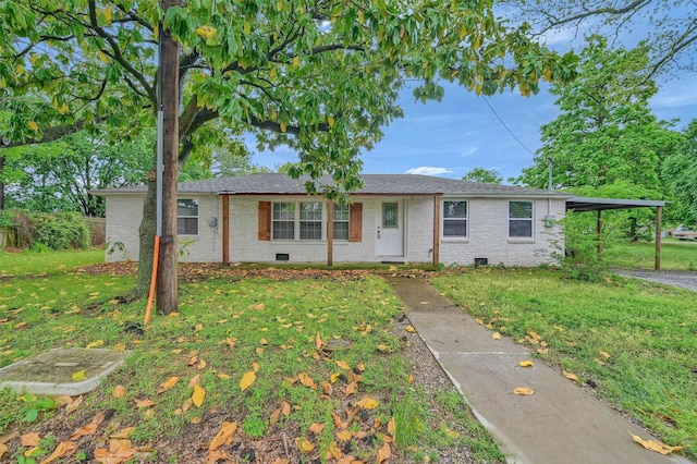 ranch-style house featuring fence, an attached carport, a front yard, and brick siding