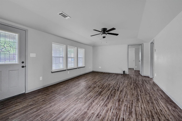 unfurnished living room with baseboards, a ceiling fan, dark wood-style floors, and visible vents