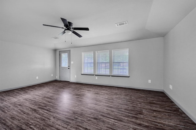 unfurnished living room featuring a ceiling fan, baseboards, visible vents, and dark wood-style floors