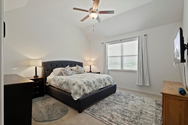 carpeted bedroom with baseboards, ceiling fan, and vaulted ceiling