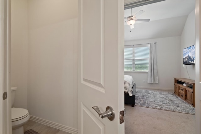 bathroom featuring baseboards, a ceiling fan, and toilet
