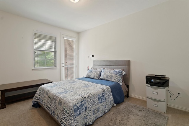 bedroom with carpet floors and baseboards