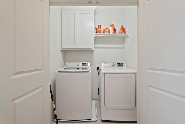 laundry room featuring cabinet space and washing machine and dryer