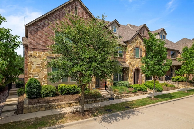 view of front of home with brick siding and stone siding