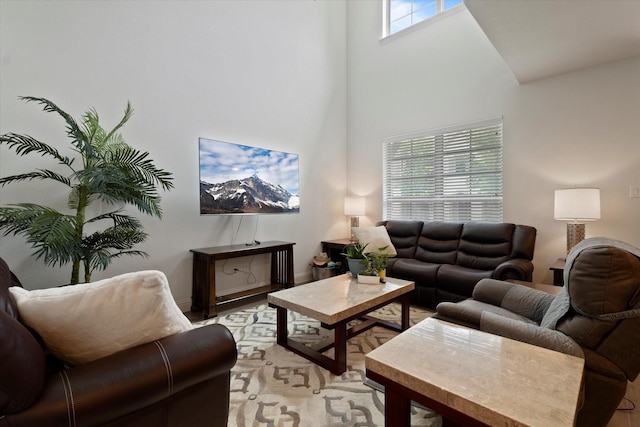 living area featuring a towering ceiling