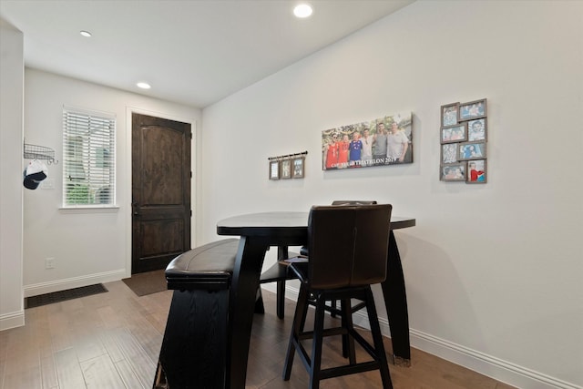 dining space featuring baseboards, recessed lighting, and wood finished floors