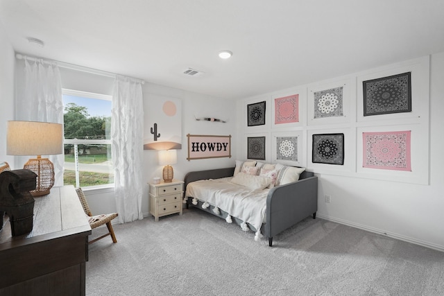 bedroom with baseboards, light carpet, and visible vents