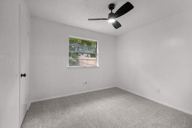 unfurnished room with baseboards, ceiling fan, carpet flooring, and a textured ceiling