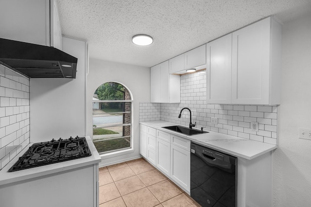 kitchen with decorative backsplash, light countertops, white cabinetry, a sink, and black appliances