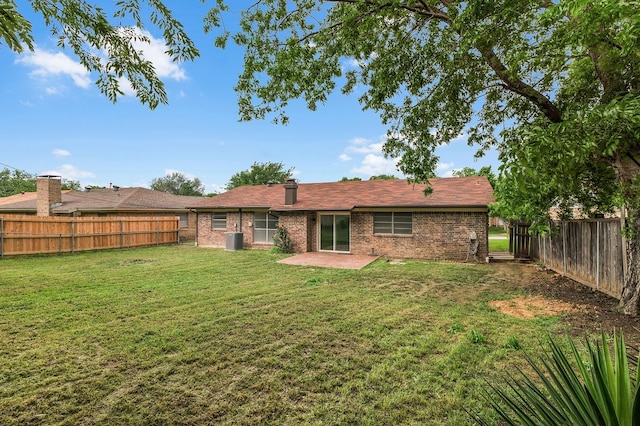 back of property featuring central AC, a patio, a fenced backyard, brick siding, and a lawn