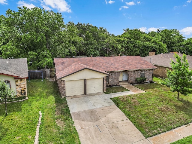 view of front of house featuring a front lawn, fence, brick siding, an attached garage, and driveway