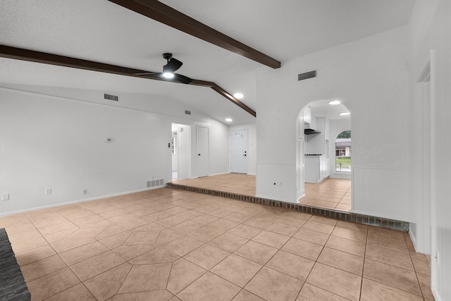 6920 Bennington Dr, Watauga, TX 76148 - unfurnished living room featuring arched walkways, lofted ceiling with beams, light tile patterned flooring, and visible vents