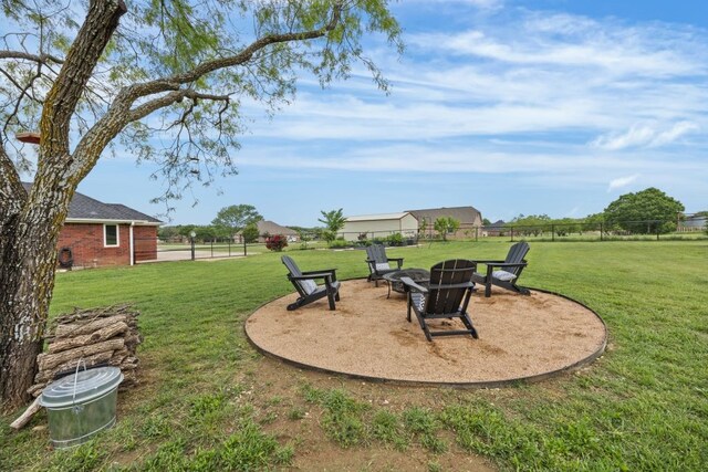 view of yard featuring fence and an outdoor fire pit