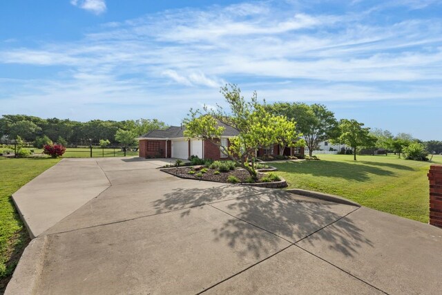 view of front facade with an attached garage, driveway, and a front yard