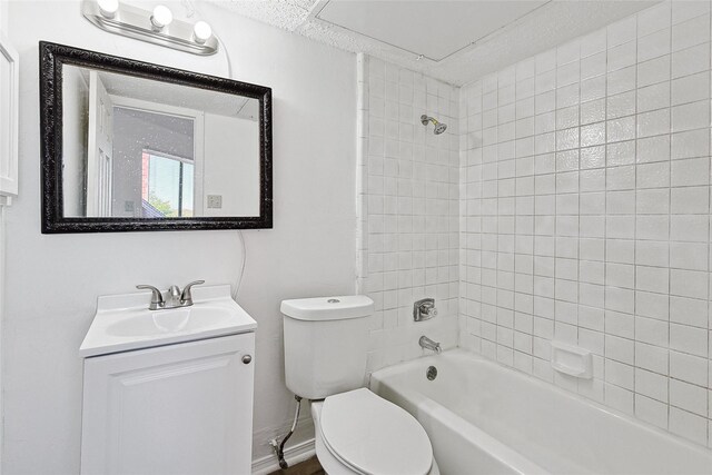 full bath featuring vanity, toilet, and shower / washtub combination