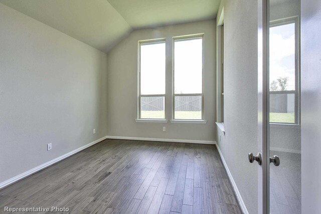 bonus room featuring baseboards, dark wood-style flooring, and lofted ceiling