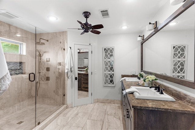 full bathroom featuring double vanity, visible vents, a sink, and a stall shower