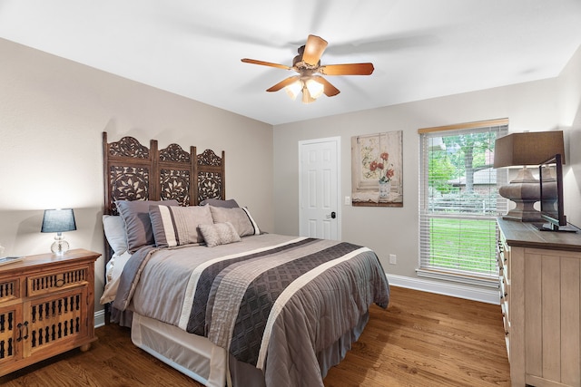 bedroom featuring baseboards, ceiling fan, and wood finished floors