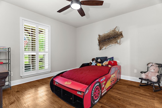 bedroom featuring baseboards, ceiling fan, and wood finished floors