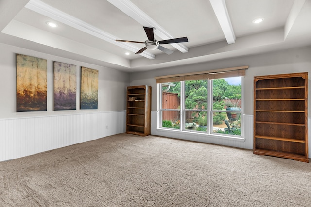 unfurnished room featuring ceiling fan, wainscoting, beamed ceiling, carpet flooring, and recessed lighting