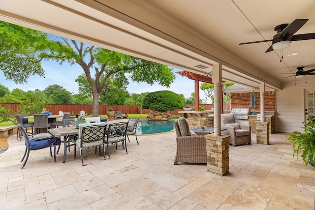 view of patio / terrace with an outdoor kitchen, outdoor dining area, and a fenced backyard