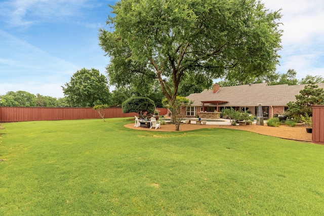 view of yard featuring fence and a patio