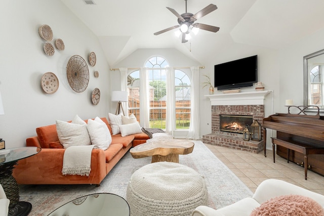 living room with plenty of natural light, ceiling fan, tile patterned floors, and a fireplace