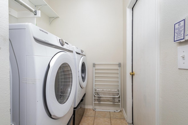 laundry area featuring separate washer and dryer, laundry area, and light tile patterned flooring