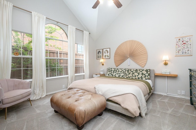 carpeted bedroom with baseboards, vaulted ceiling, and multiple windows