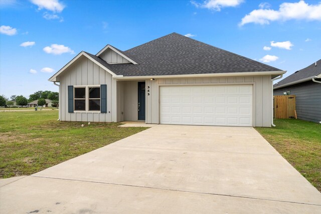 343 Preston Rd, Mabank, TX 75147 - view of front of home with a shingled roof, a garage, board and batten siding, a front yard, and driveway