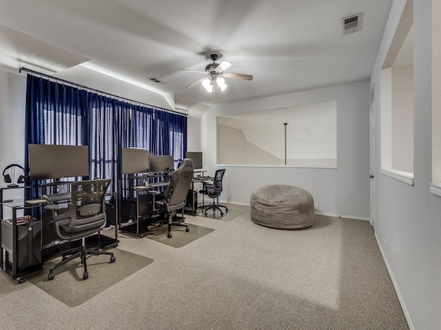 office area with baseboards, carpet, a ceiling fan, and visible vents