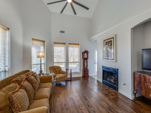 living area with a fireplace, ceiling fan, visible vents, and hardwood / wood-style floors